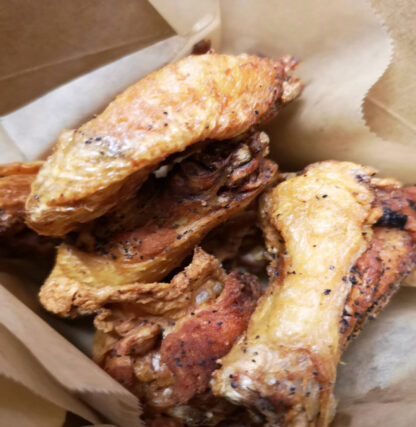 Crispy fried chicken wings with golden breading in a bowl.